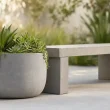 Concrete planter with succulents by bench