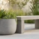 Concrete planter with succulents by bench